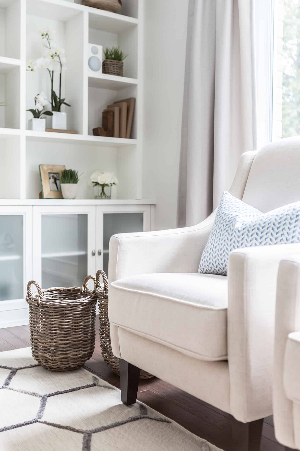 White chair with two baskets next to it