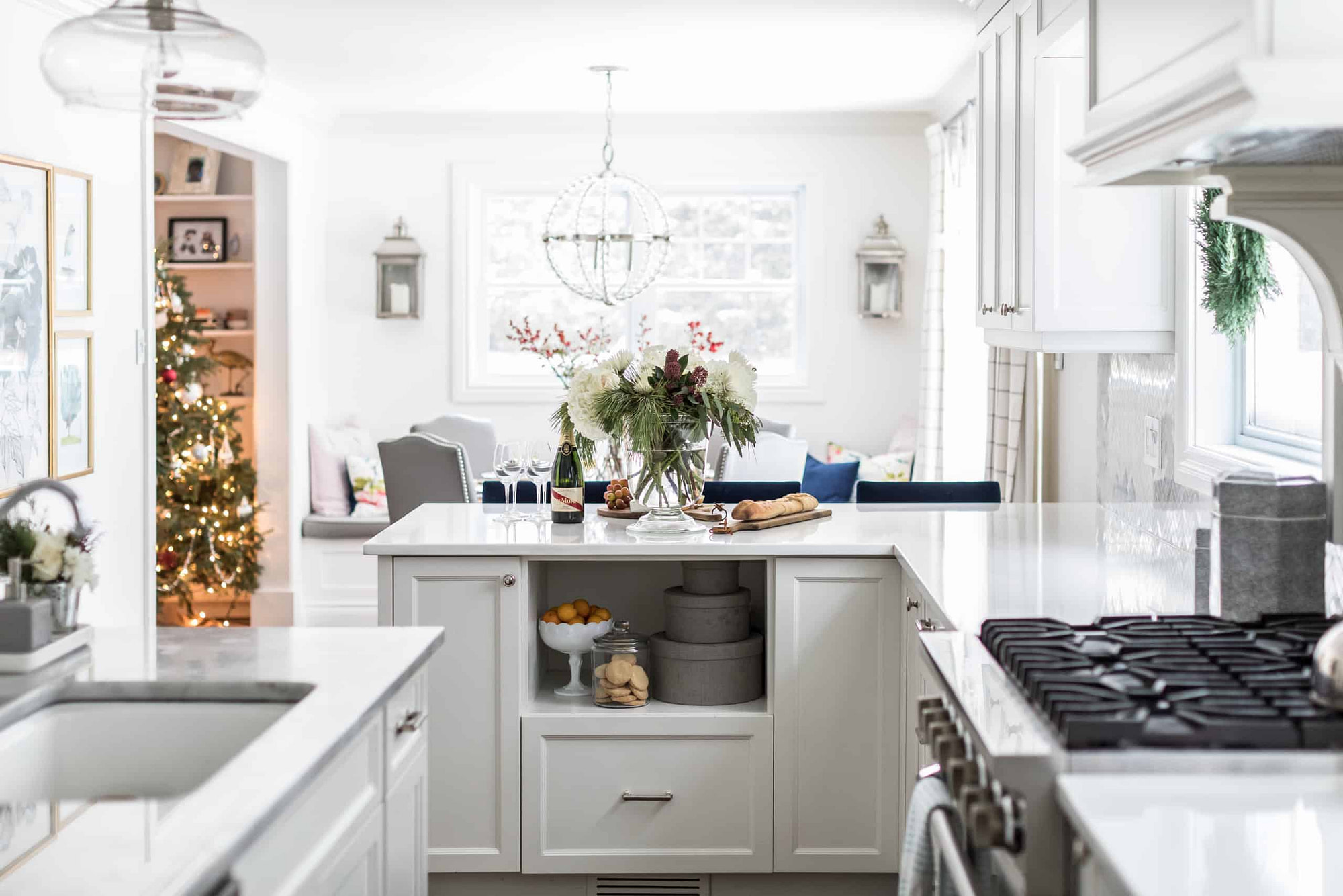 White, modern living room decorated for Christmas